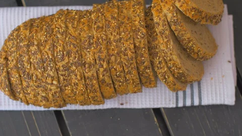 Tasty whole-grain bread on a black background Stock Footage 109551127