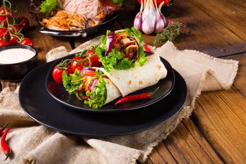 Tasty wraps filled with pulled pork and salad Stock Photos