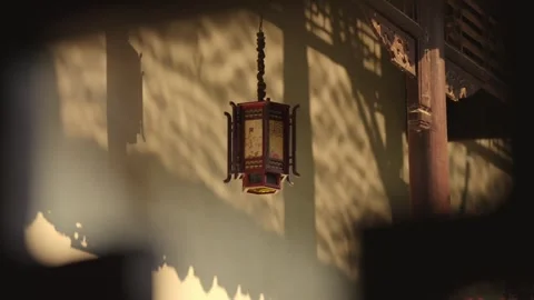 Tatic shot of Chinese lantern with moving tree shadow on ancient wall Stock Footage 345103495