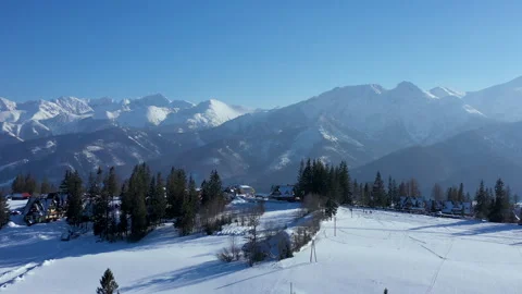 Tatra Mountains in winter aerial pullback over snowy Podhale meadow Stock Footage 346664120