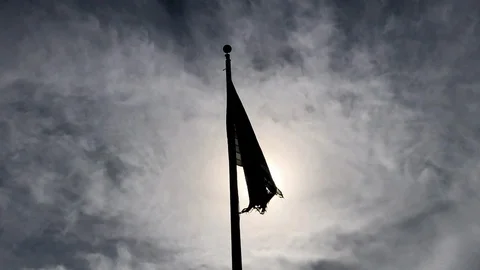 Tattered American Flag Backlit on Flagpole Stock Footage 104633653