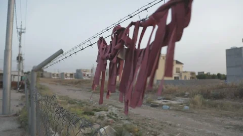 Tattered cloth on barbed wire Stock Footage 87760171
