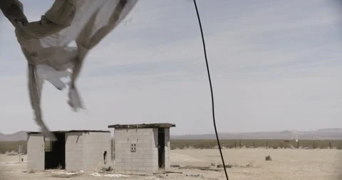 Tattered Curtains in Foreground with Cement Shack in Background Stock Footage 89943204