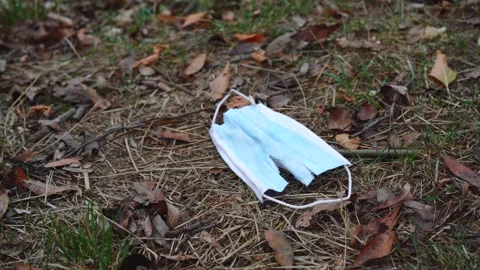 Tattered mask lying on the ground Stock Footage 145924547