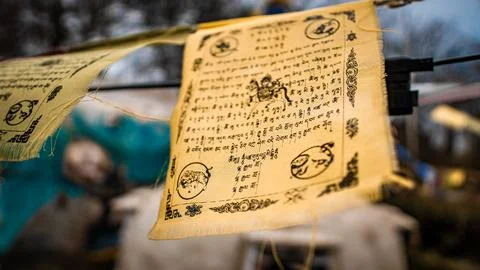 Tattered prayer flags flutter in the wind Stock Photos
