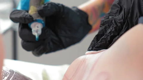 Tattoo artist makes an abstract tattoo on a girl Stock Footage 180272653