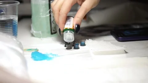 Tattoo Artist Prepares Disposable Ink Cup Before Work. Woman Working. Green Ink Stock Footage