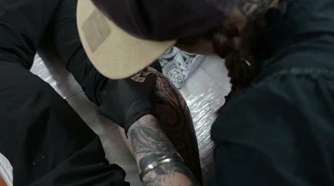 Tattoo artist using sketch as reference Stock Footage 47469821