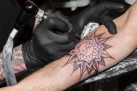 Tattoo in form of circular pattern on man's arm Foto stock