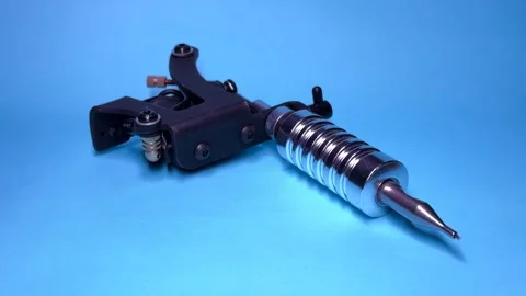 Tattoo Machine on Blue Background Stock Footage 303383101