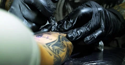 Tattoo machine. creating picture on hand with it in salon Stock Footage 139707721