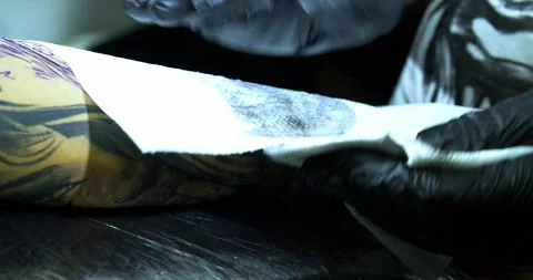 Tattoo machine. creating picture on hand with it in salon Stock Footage 139707780