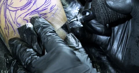 Tattoo machine. creating picture on hand with it in salon Stock Footage 139707826