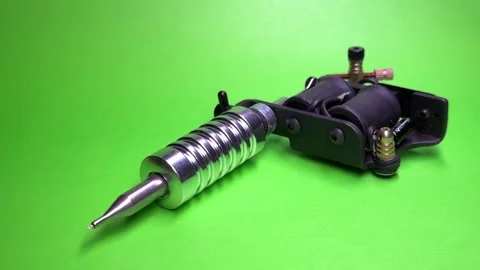 Tattoo Machine on Green Background Stock Footage 303382641