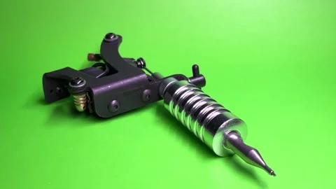 Tattoo Machine on Green Background Stock Footage 303382642