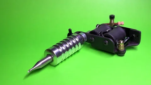 Tattoo Machine on Green Background Stock Footage 303382643