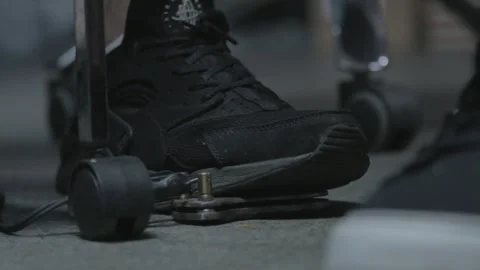 Tattoo machine pedal pressed with black shoe. Side view Stock Footage 148677135