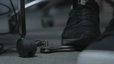 Tattoo machine pedal pressed with black shoe. Front view Stock Footage 148677176