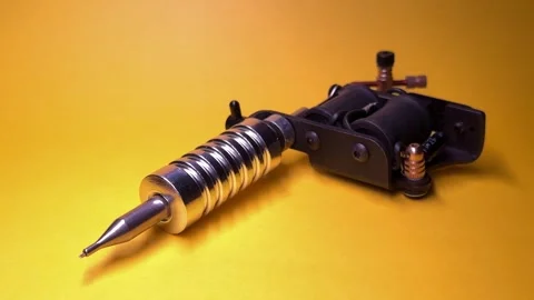 Tattoo Machine on Yellow Background Stock Footage 303381881