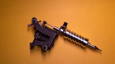 Tattoo Machine on Yellow Background Stock Footage 303381888