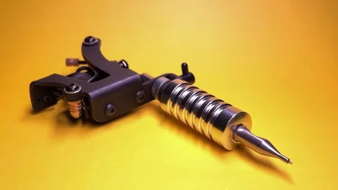 Tattoo Machine on Yellow Background Stock Footage 303381890