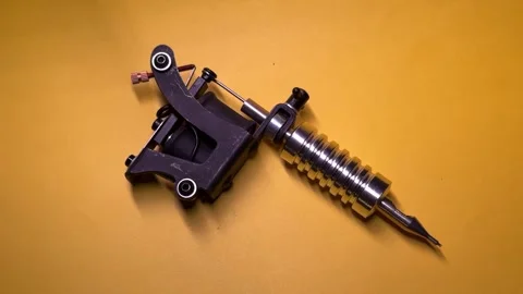 Tattoo Machine on Yellow Background Stock Footage 303381902