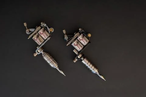 Tattoo machines on black background Stock Photos