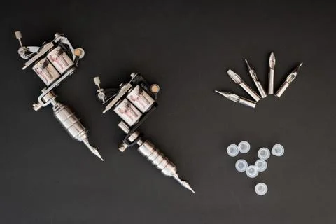 Tattoo machines on black background Stock Photos