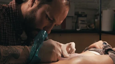 Tattoo master with beard making a tattoo of mandala pattern. Close up shot Stock Footage 67521140