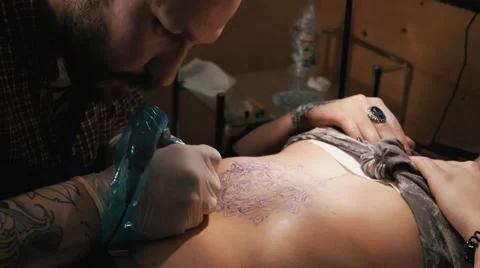 Tattoo master with beard making a tattoo of mandala pattern. Close up shot Stock Footage 67521394