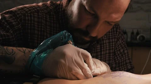 Tattoo master with beard making a tattoo of mandala pattern. Close up shot Stock Footage 67532135