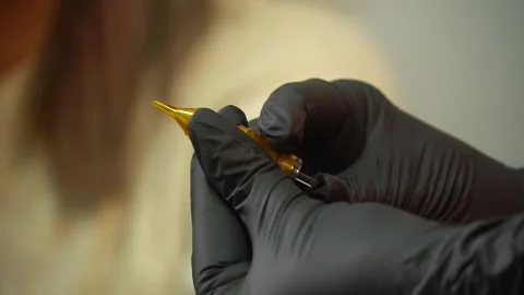 Tattoo master checks needles and tattoo machine. tattoo parlor Stock Footage 232046353
