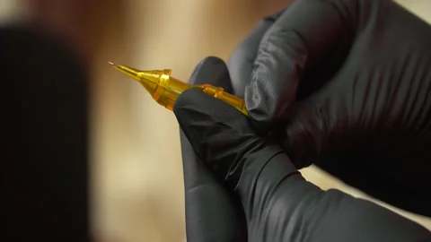 Tattoo master checks needles and tattoo machine. tattoo parlor Stock Footage 232046357