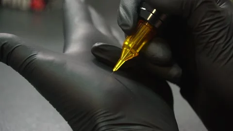 Tattoo master checks needles and tattoo machine. tattoo parlor Stock Footage 232046365