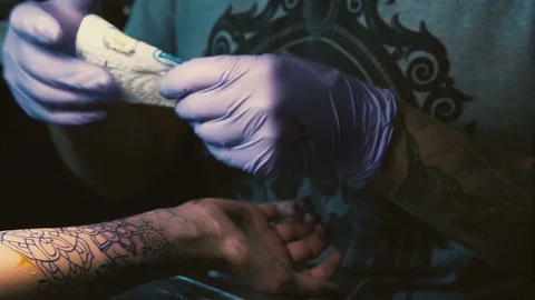 Tattoo master does tattoo on hand close-up Stock Footage 73176051