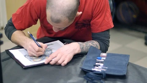 Tattoo master draw picture Stock Footage 88378007