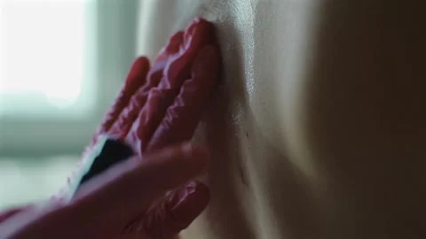 Tattoo master in gloves preparing skin before tattooing in studio. Hygiene Stock Footage 250627556