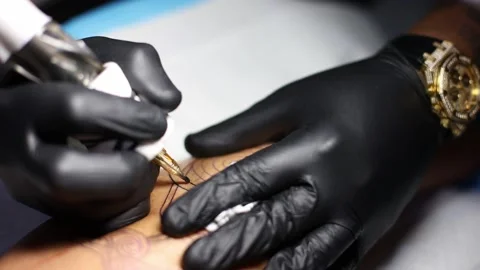 Tattoo master hands busy with work at tattoo salon. Close up. Video stock 171879718