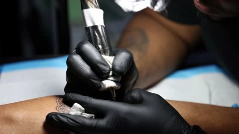 Tattoo master hands busy with work at tattoo salon. Close up. Video stock 189549638
