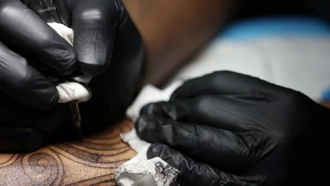 Tattoo master hands busy with work at tattoo salon. Close up. Stock Footage 195731945