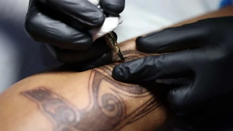 Tattoo master hands busy with work at tattoo salon. Close up. Video stock 197568287
