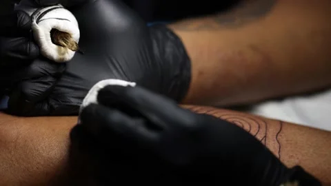 Tattoo master hands busy with work at tattoo salon. Close up. Stock Footage 231496446