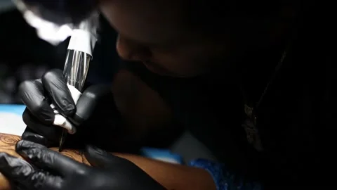 Tattoo master hands closeup busy with putting tattoo. Stock Footage 166949307