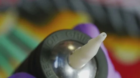 Tattoo master holding a tattoo machine close-up Stock Footage 73156115