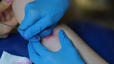 Tattoo master makes a tattoo on the client's hand. Hand poke tattoo. Small Video stock 212428188