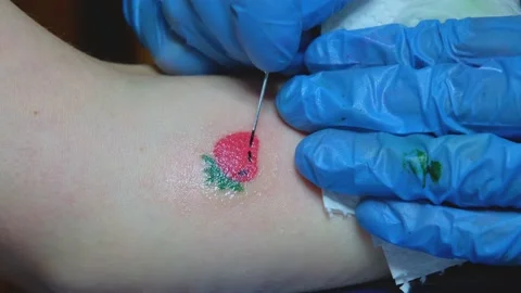 Tattoo master makes a tattoo on the client's hand. Hand poke tattoo. Small Stock Footage 218464083
