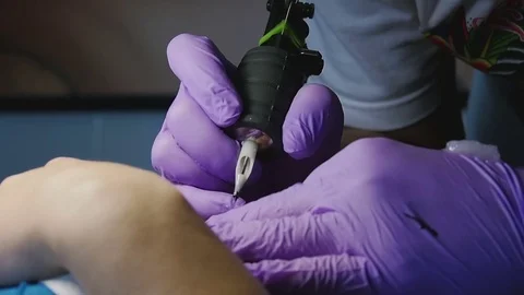 Tattoo master makes the tattoo close-up Stock Footage 73138370