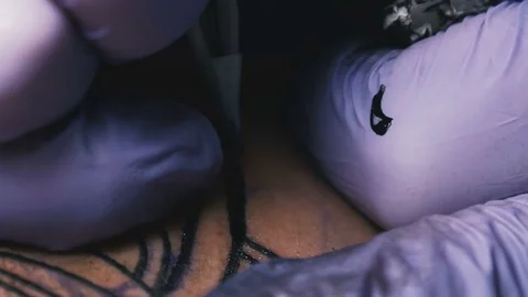 Tattoo master makes the tattoo close-up Stock Footage 73141794