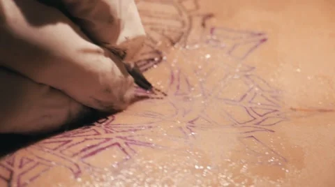 Tattoo master making a tattoo of mandala pattern. Close up shot of hands Stock Footage 67514699