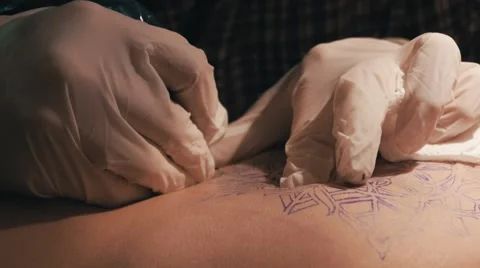 Tattoo master making a tattoo of mandala pattern. Close up shot of hands Stock Footage 67515456